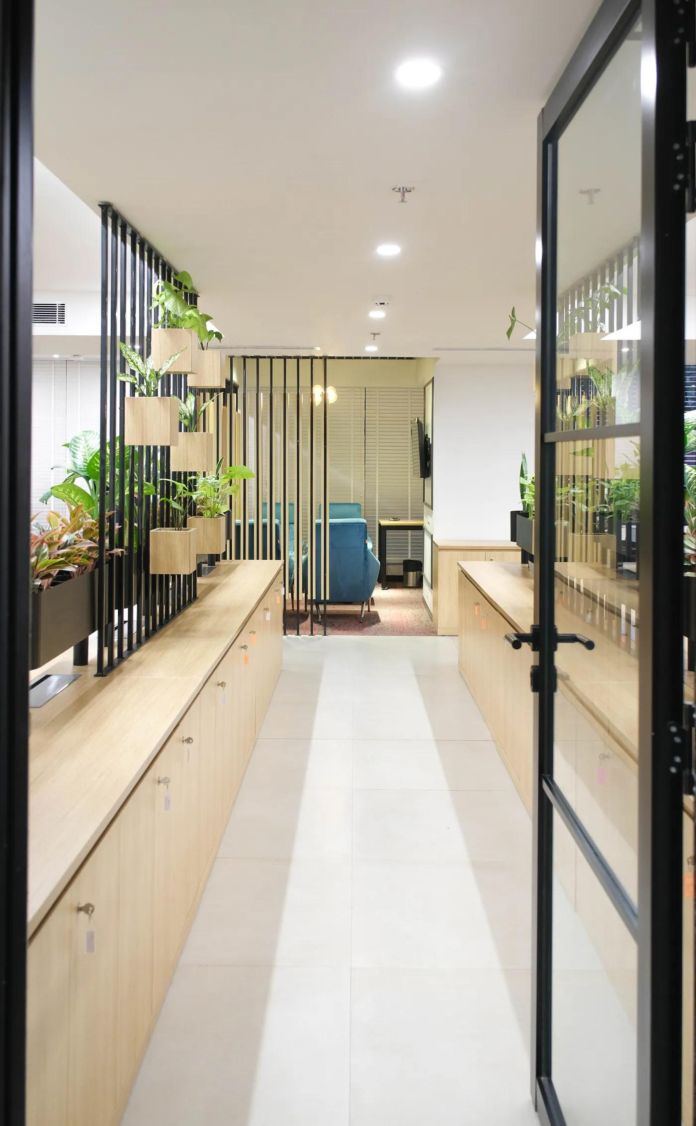AIHP Milestone quiet breakout cabin behind a wood-slat divider with lounge seating, Udyog Vihar Gurgaon