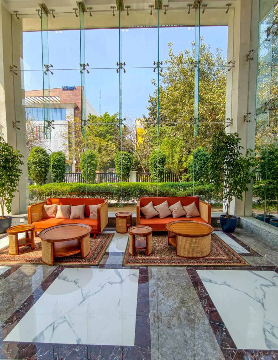 AIHP Atrium signature outdoor terrace lounge with sofa seating and landscaped greenery, Sector 32 Gurgaon