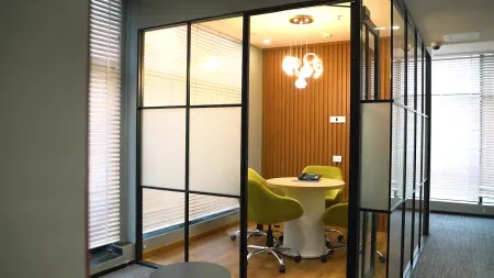 AIHP Milestone private glass-walled meeting room with wood feature wall, Udyog Vihar Gurgaon