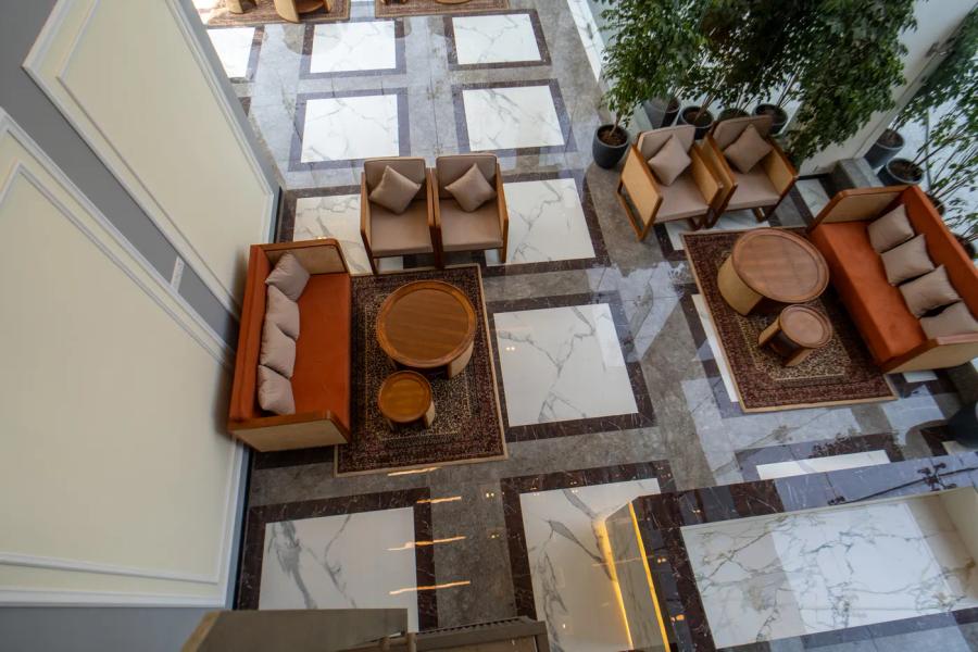 AIHP Atrium overhead view of the atrium lounge with sofa seating on patterned marble flooring, Sector 32 Gurgaon