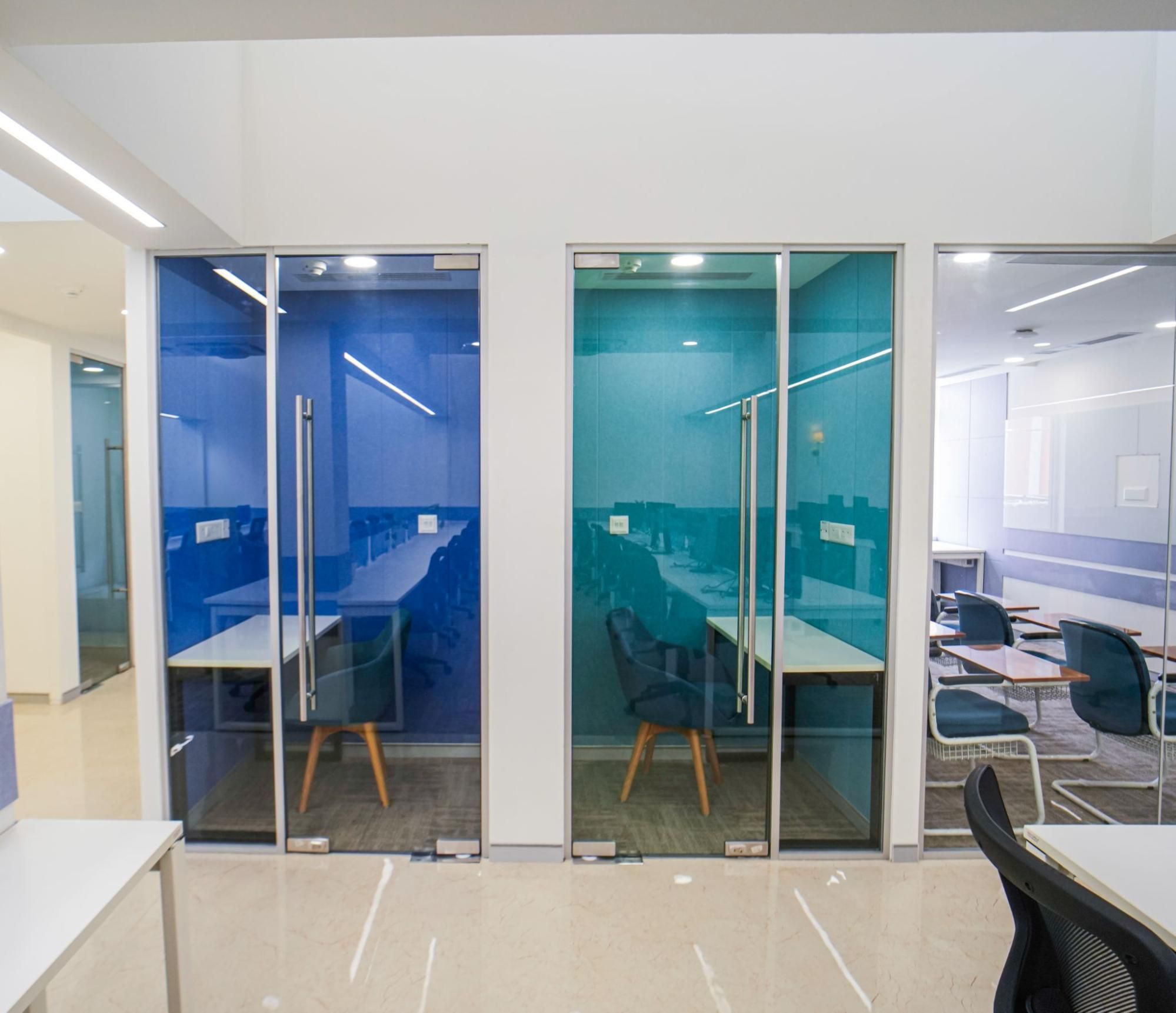 Office corridor between glass cabins at AIHP 507-508, Udyog Vihar