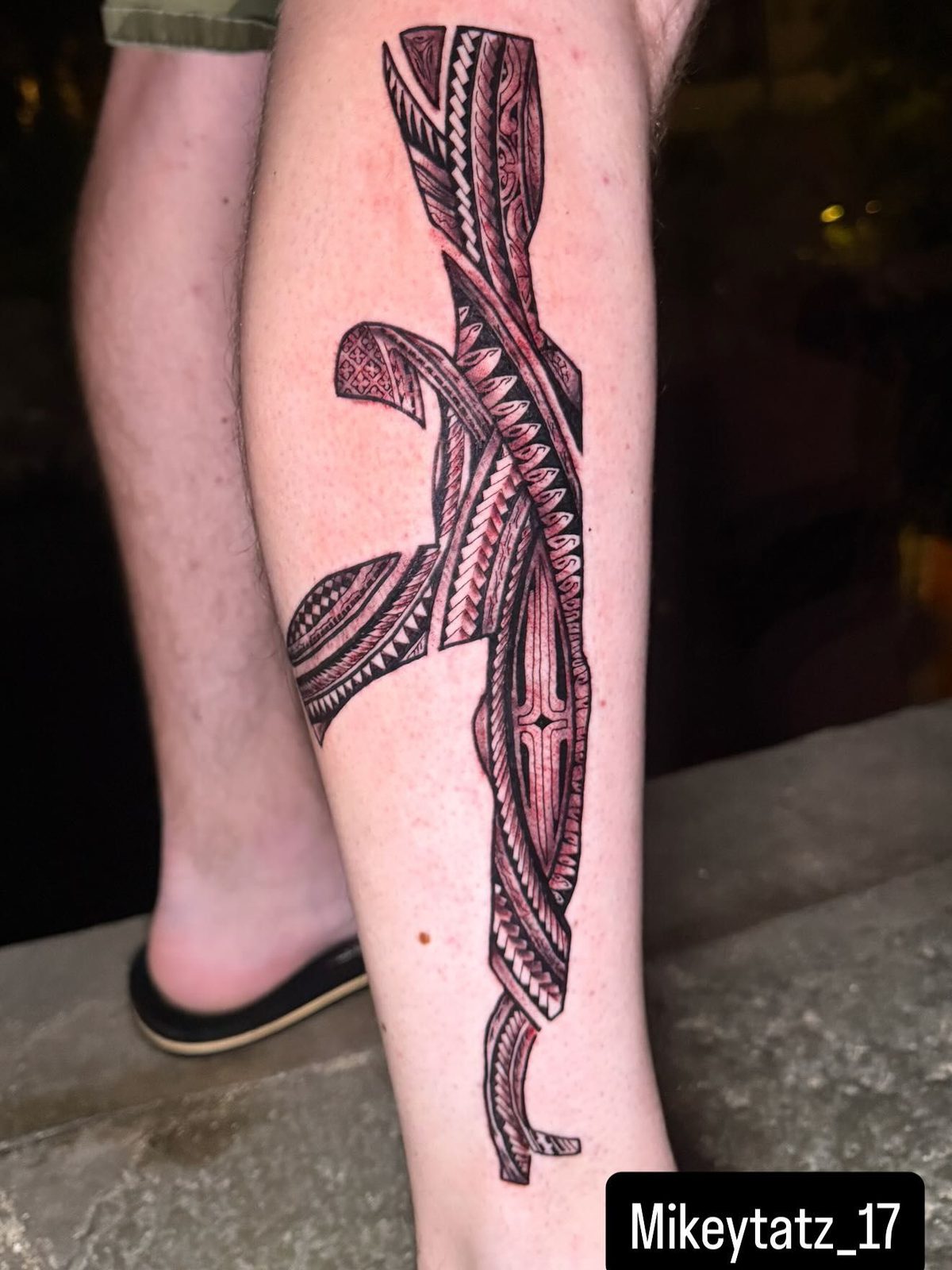 Detailed Polynesian tribal piece featuring traditional geometric patterns and motifs on the calf.
