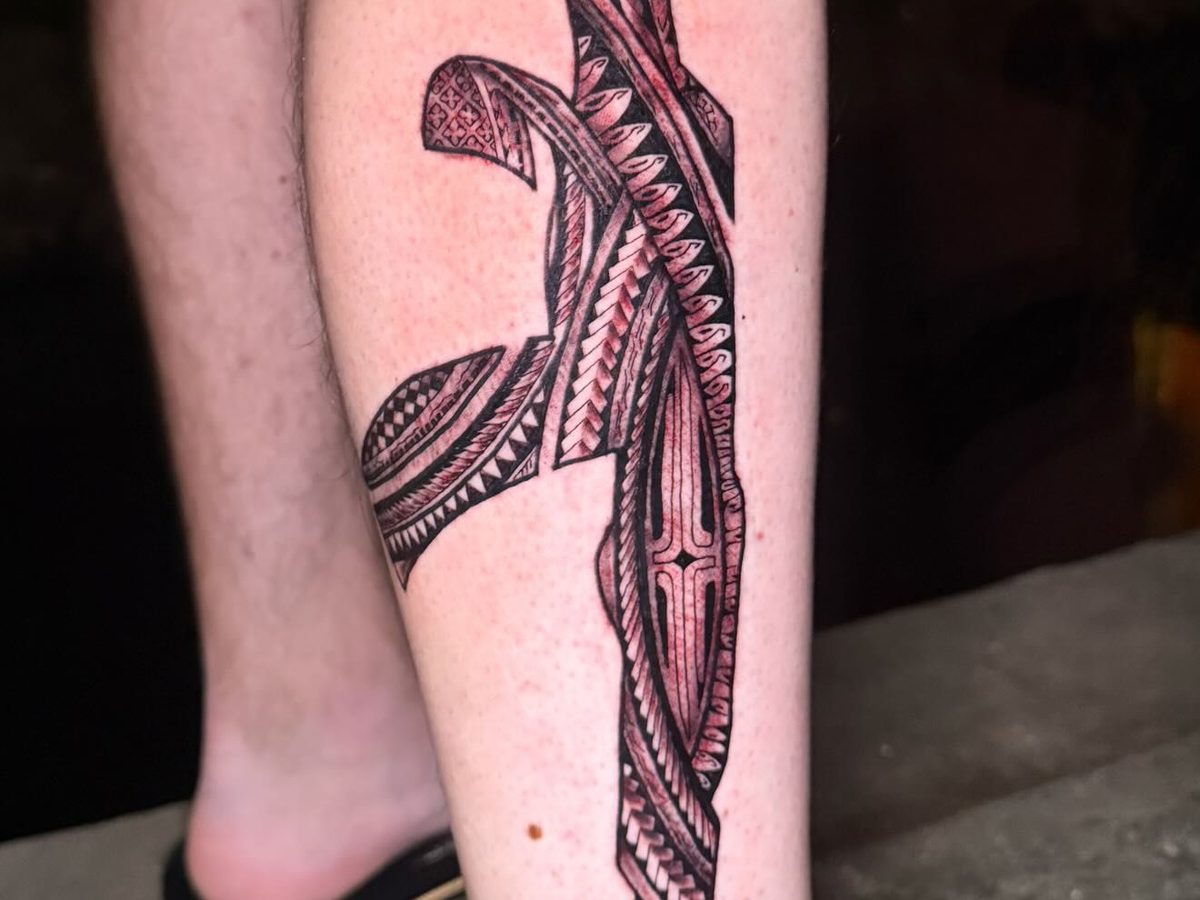 Detailed Polynesian tribal piece featuring traditional geometric patterns and motifs on the calf.