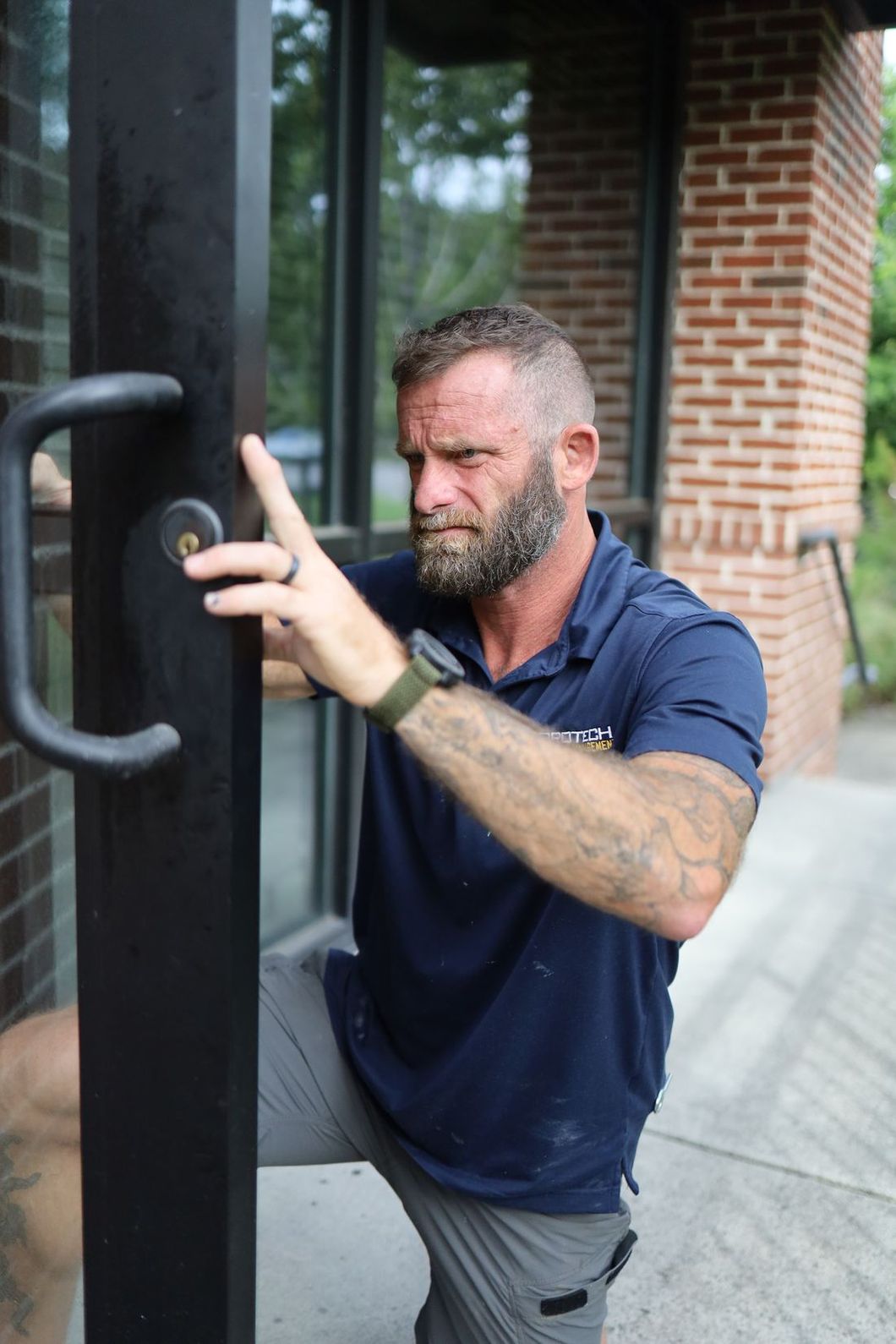 ProTech technician servicing a storefront door