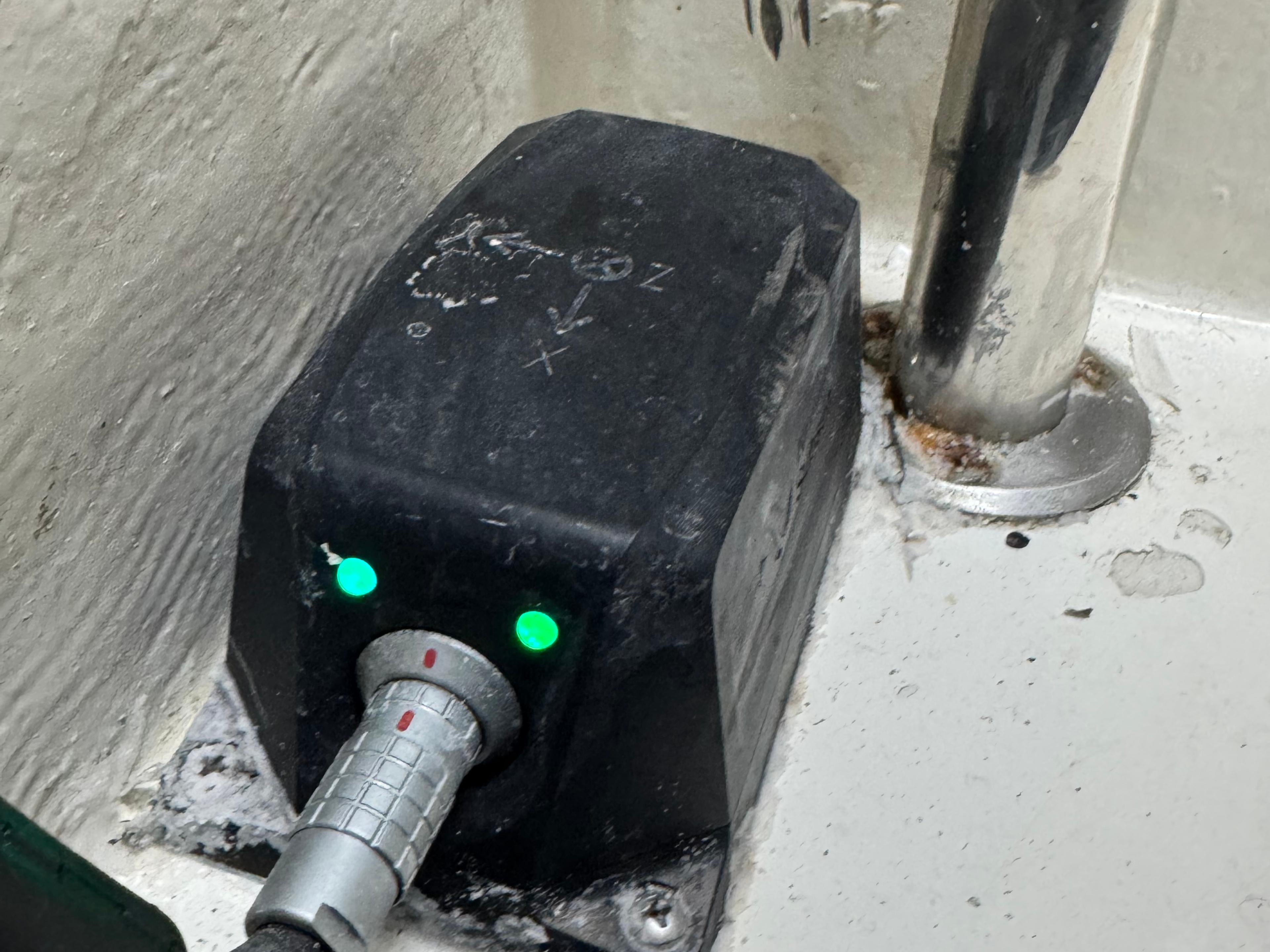 A black marine Motion Reference Unit in situ