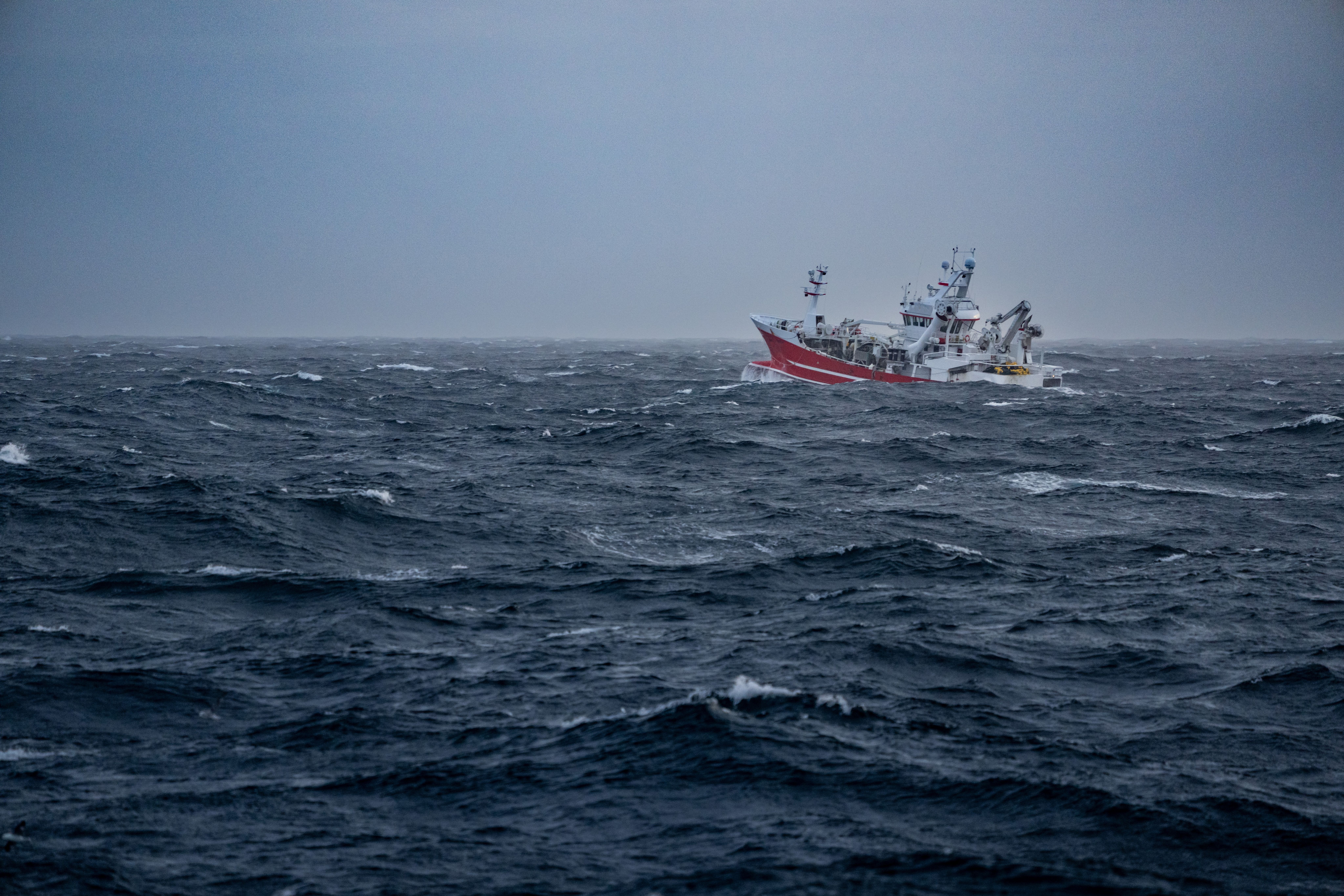 picture of Fishing boat trawler sailing out at rough sea