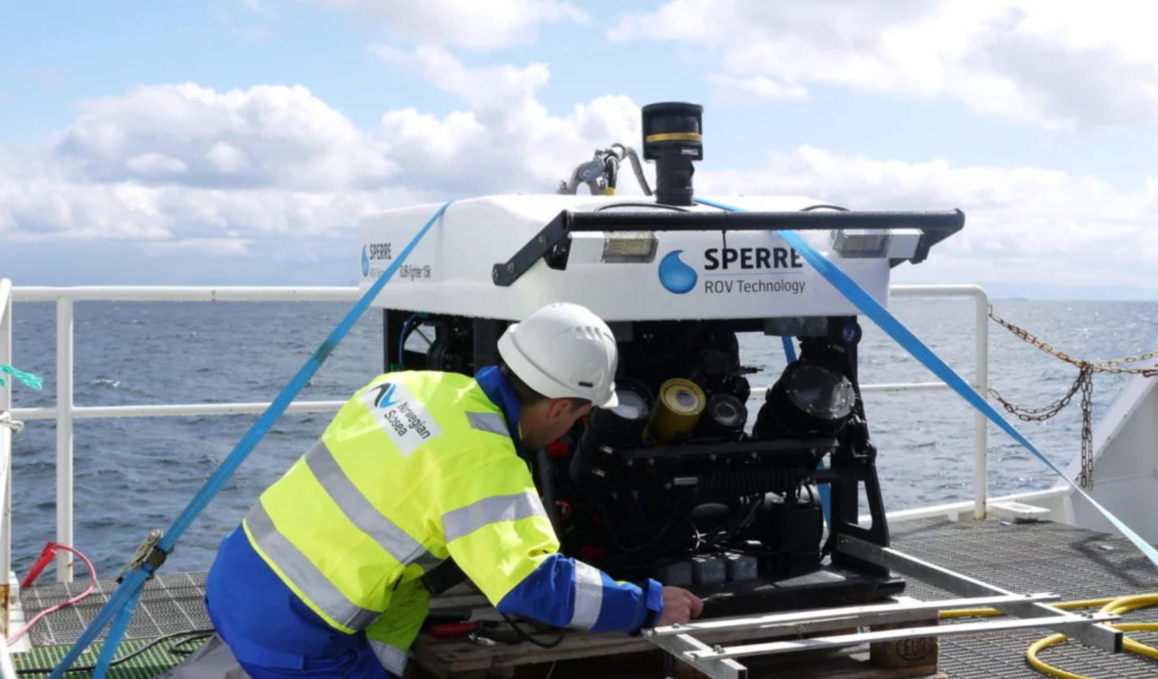 An employee with a remotely operated vehicle on a ship