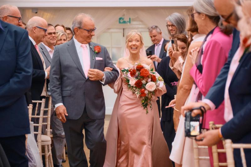 Groom and guests walking together during a wedding celebration procession