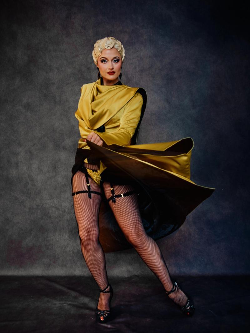 Fashion portrait of a model in a bold gold couture dress with strong lines