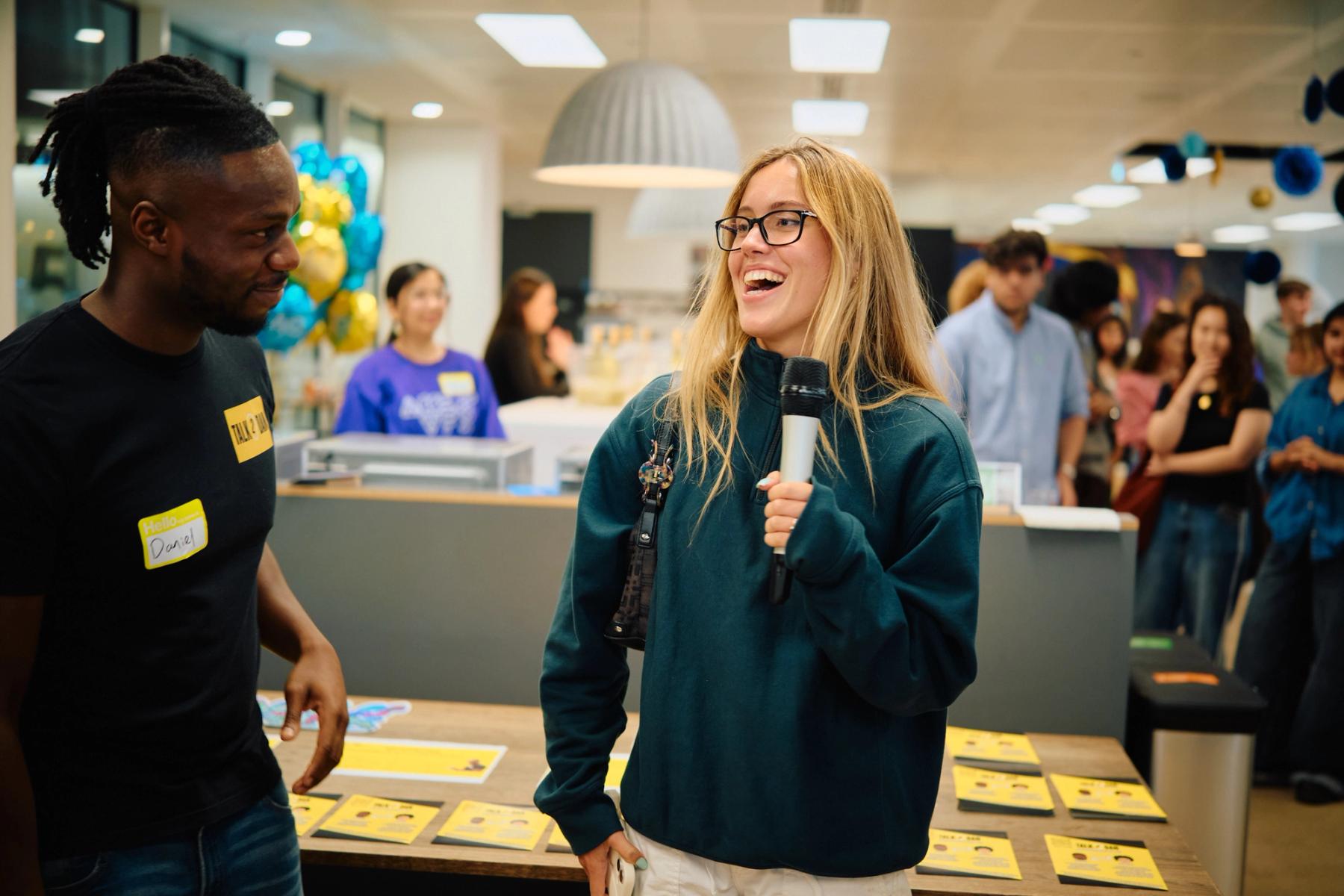 Access VFX community event 2026, blonde woman with a microphone laughing during an interview with Daniel