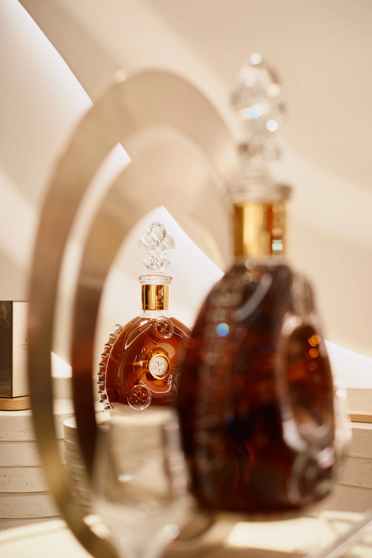 Louis XIII cognac bottles displayed on an elegant table at a wedding reception venue