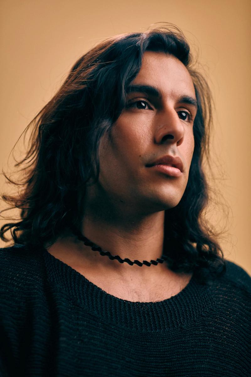 Studio portrait of a young man in a black top with soft directional light