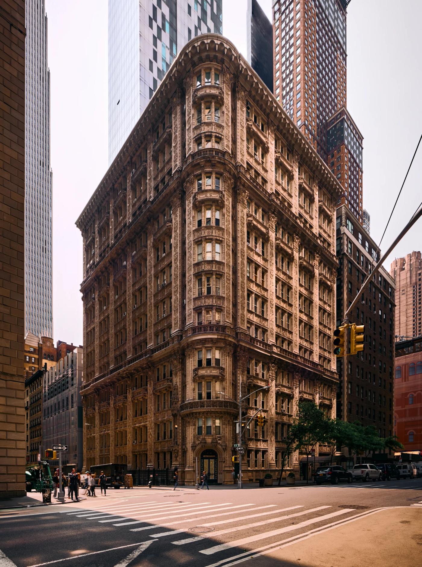 The Flatiron Building in New York City, a historic landmark, is captured in a low-angle photo, emphasizing its grandeur and architectural details.
