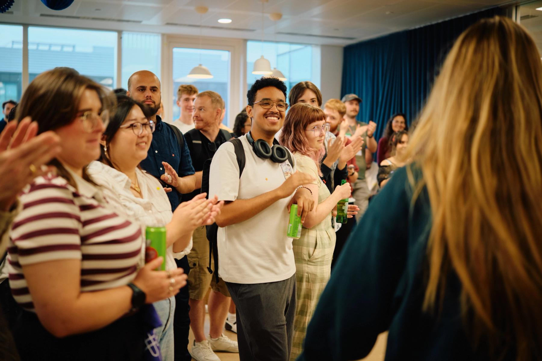 Access VFX community event 2026, diverse crowd smiling and clapping during a presentation