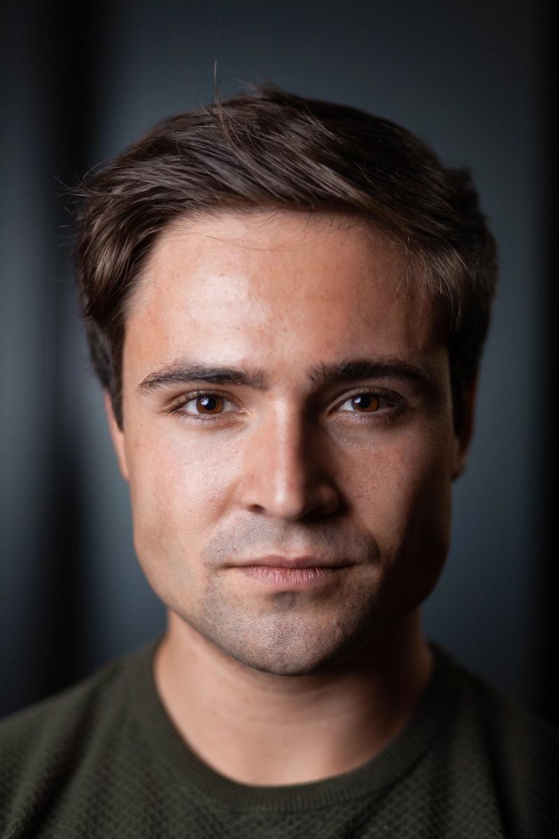 Color studio headshot of a man with soft, even portrait lighting