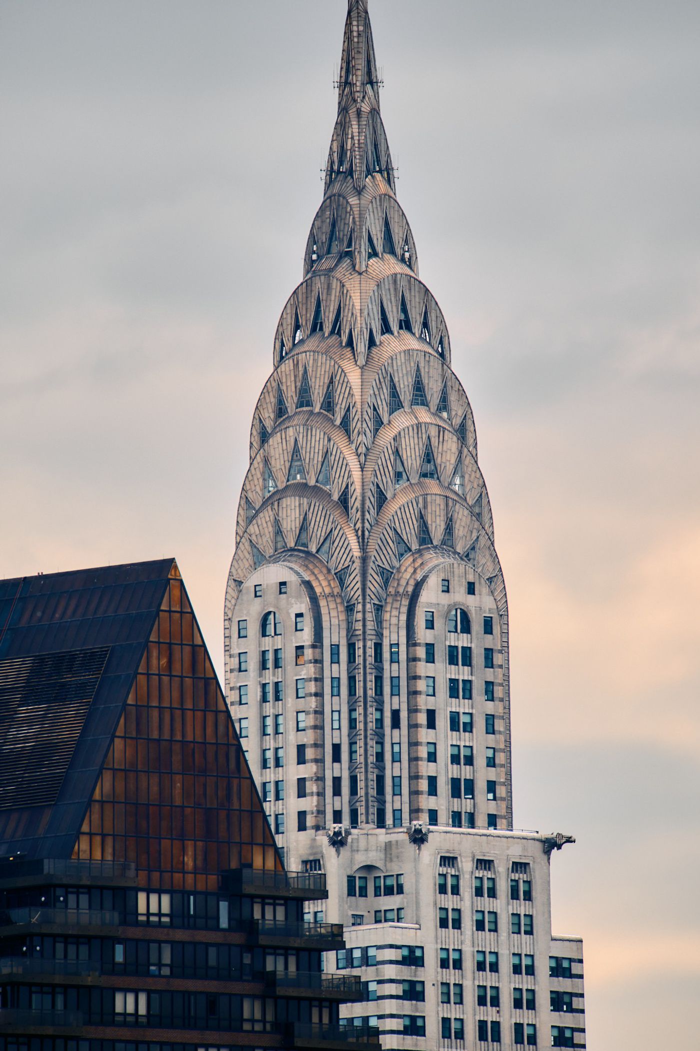 The Empire State Building, a skyscraper in New York City, is captured in a low-angle shot, emphasizing its height and grandeur. The building's white f