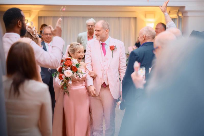 Bride smiling among guests during the wedding reception