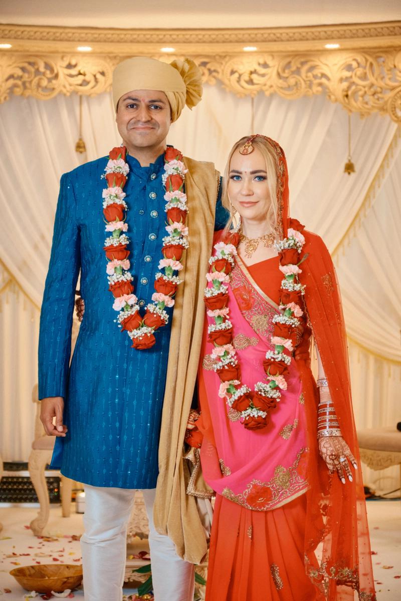 Bride and groom in colorful traditional attire during a wedding ritual