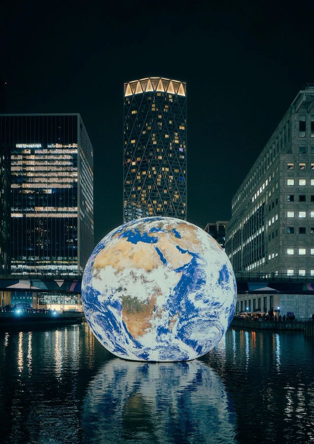 Floating Planet - This stunning urban photo of our dear planet Earth floating in a wharf will provoke a thoughtful conversation with anyone who sees it on your wall.