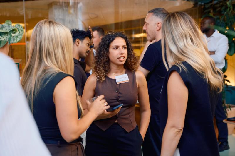 A group of people standing around talking.