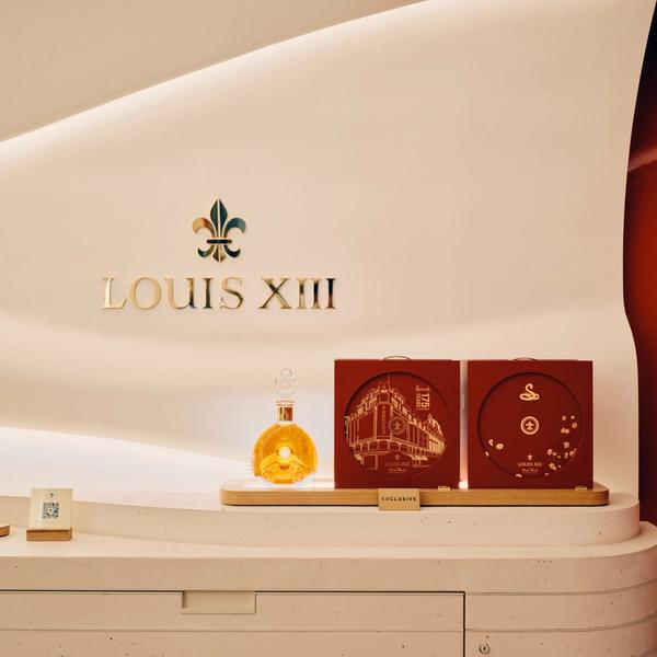 Louis XIII luxury cognac signage in store with decanter and soft lighting in a modern interior design environment