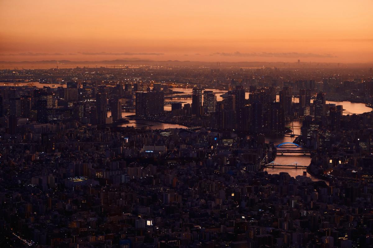 Empire State Building Art Deco skyscraper with tiered crown and spire dominating Manhattan skyline at golden hour sunset, New York City