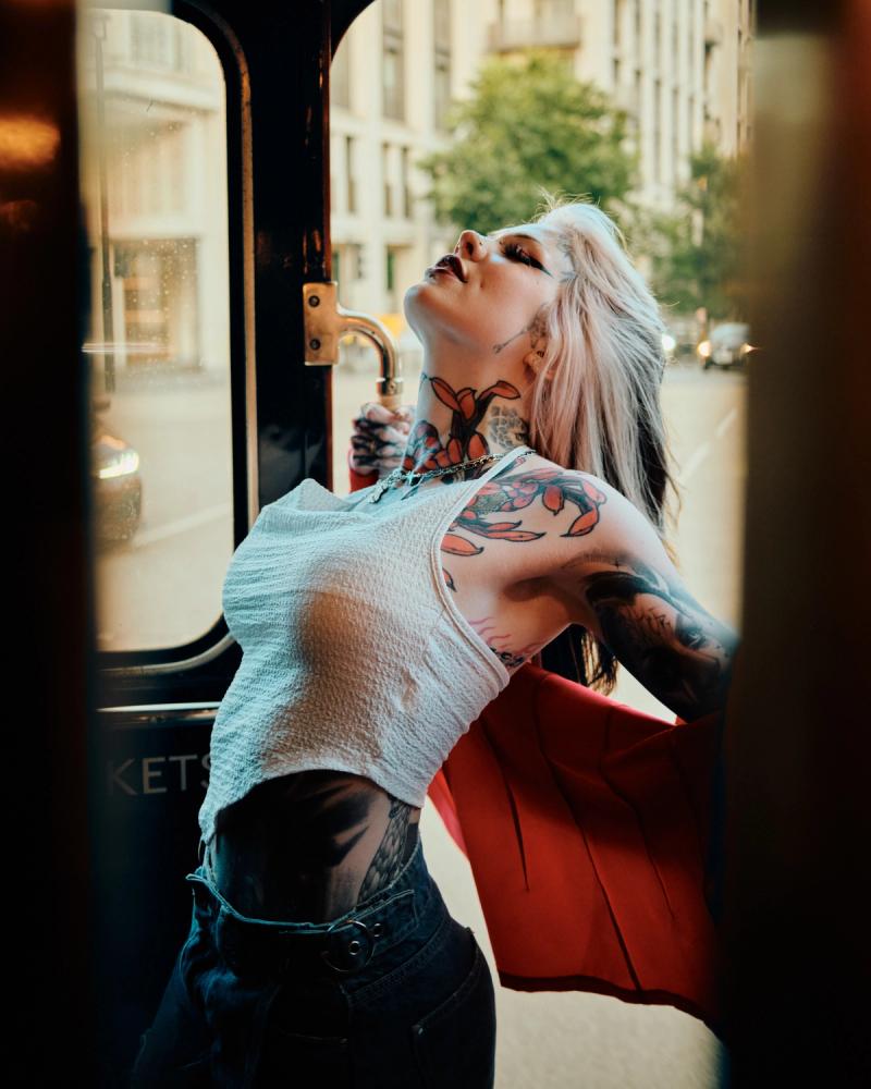Blonde woman reclining in a diner booth during a cinematic portrait shoot