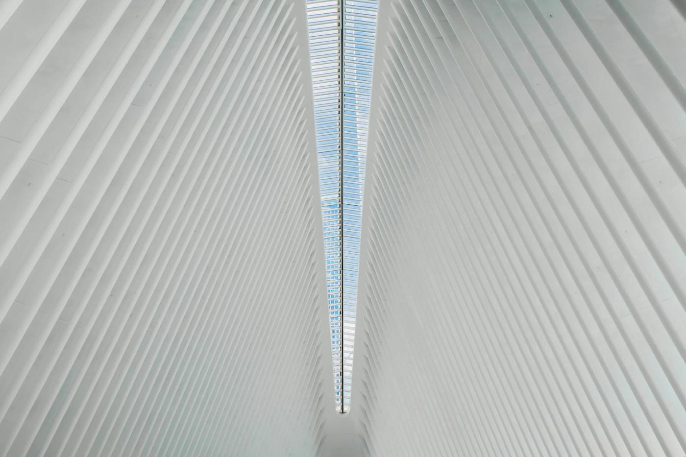 The image showcases the grandeur of the New York Public Library in New York City, featuring a modern architectural design with a curved ceiling and a 