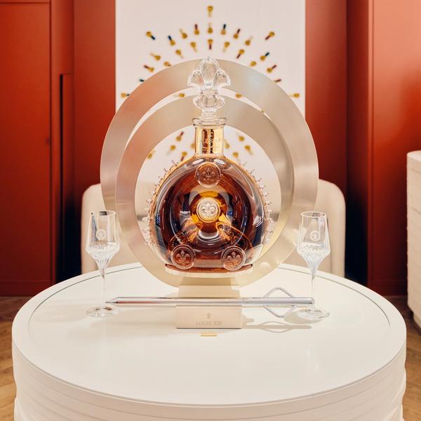 Louis XIII luxury cognac signage in store with decanter and soft lighting in a modern interior design environment
