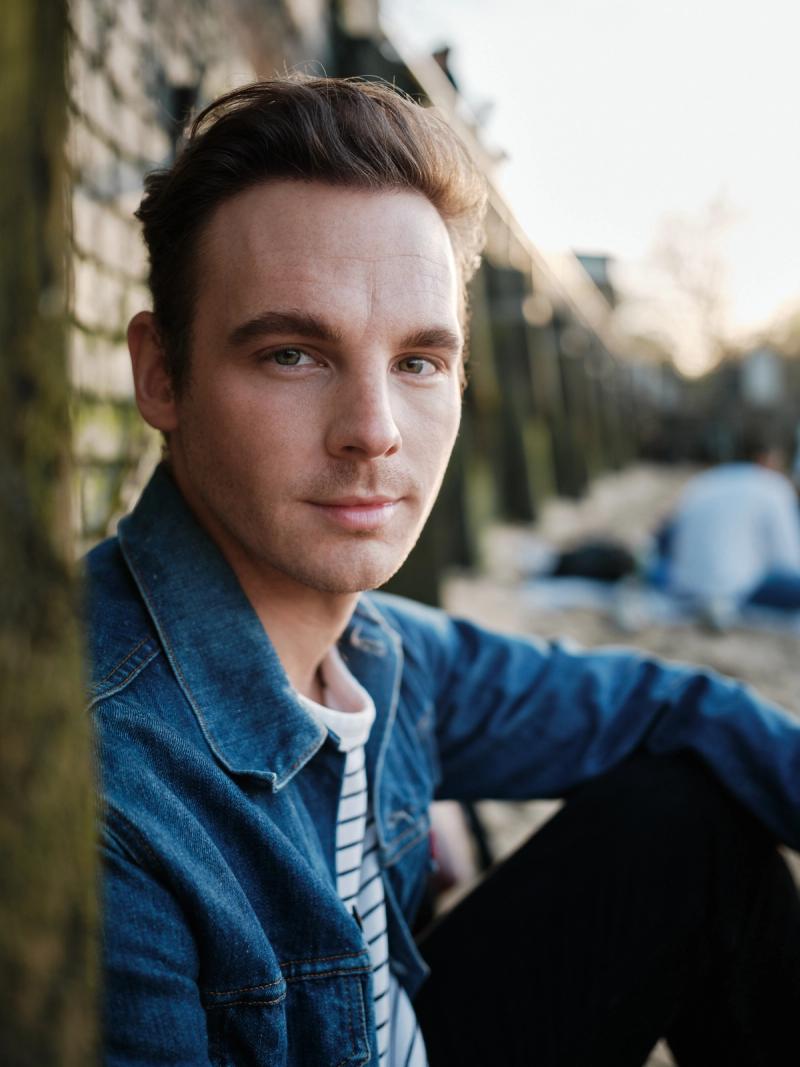 Close-up portrait of a man with soft sunset bokeh behind him