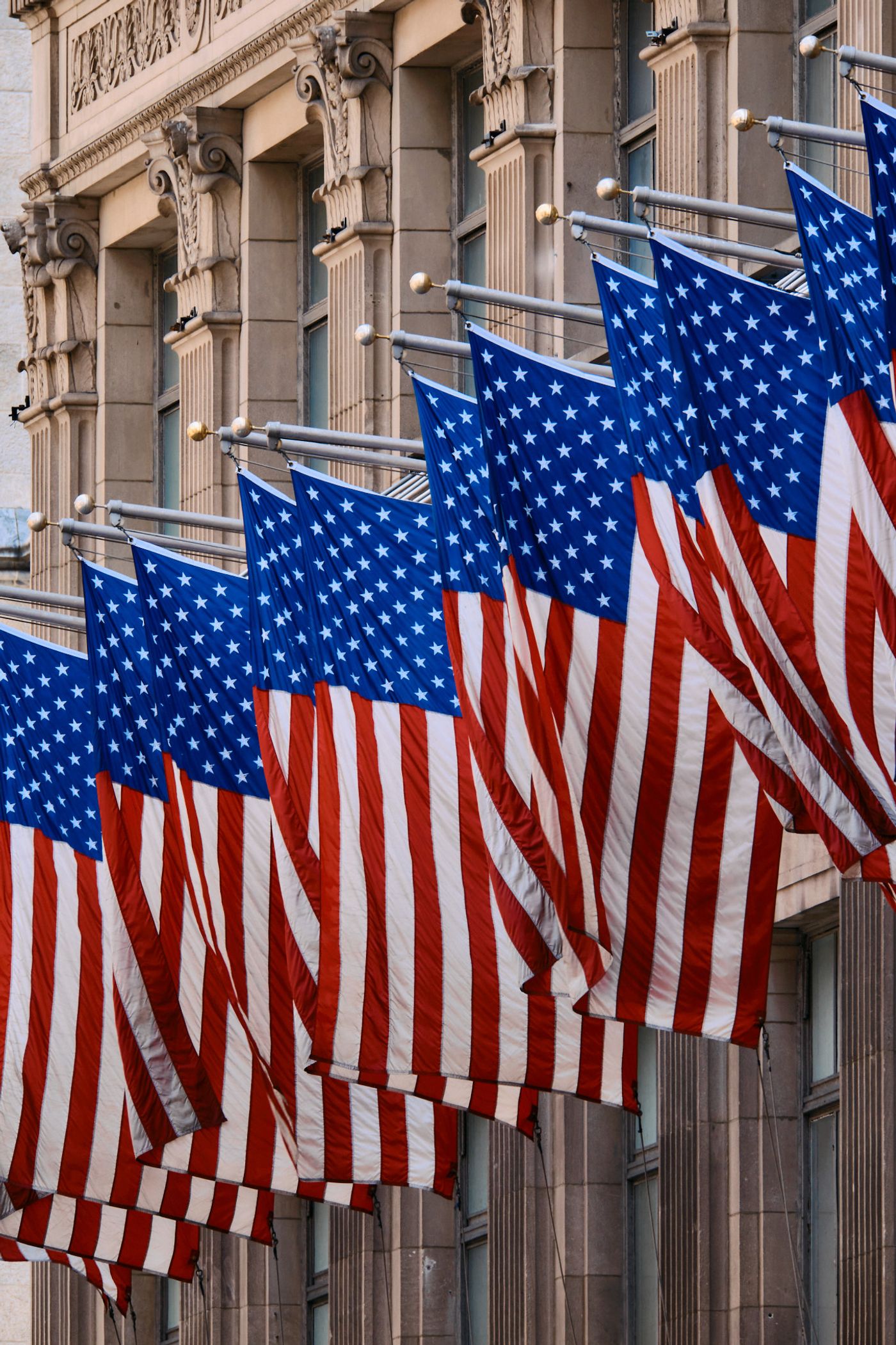 American flags are hung on a building, creating a patriotic scene.