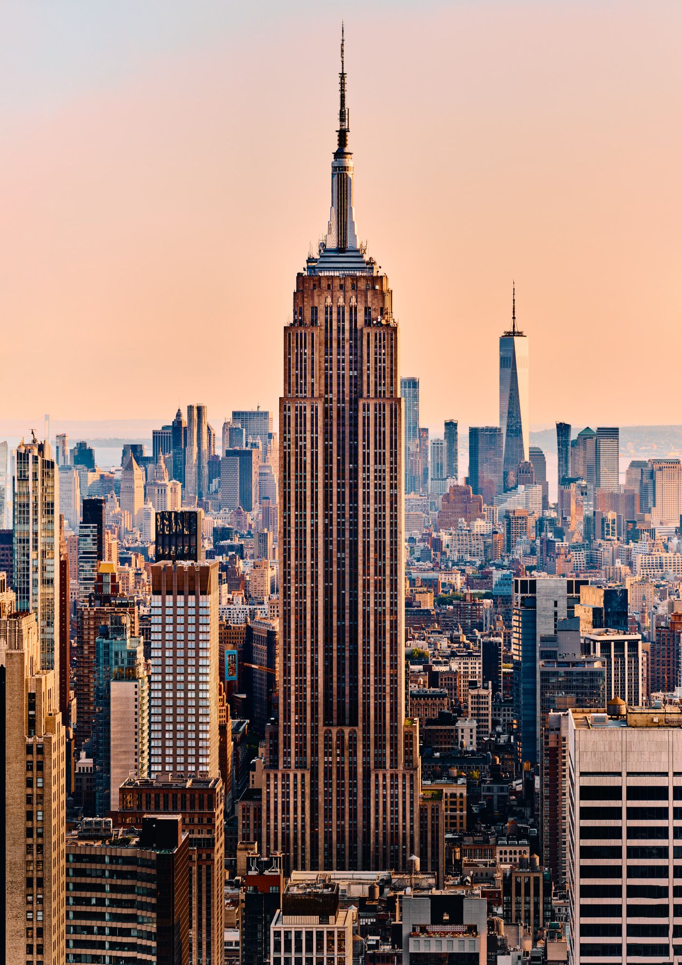 The Empire State Building is prominently featured in a cityscape, with its towering structure dominating the skyline.