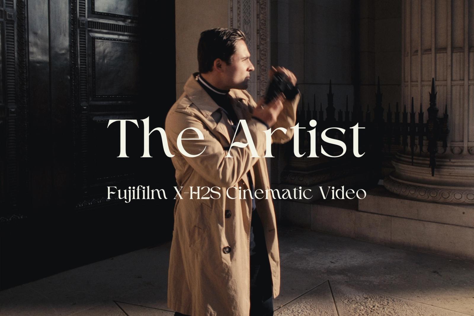 Man in trench coat, holding camera, wearing black tie, standing in front of a black door with a white frame, text overlay "The Untie" and "Fernando Vi
