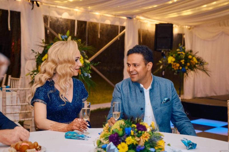 Couple seated at a decorated wedding table during the reception