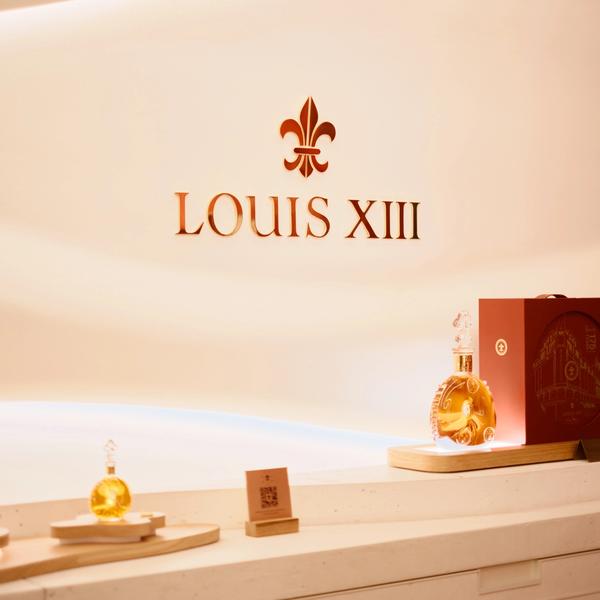 Louis XIII luxury cognac signage in store with decanter and soft lighting in a modern interior design environment