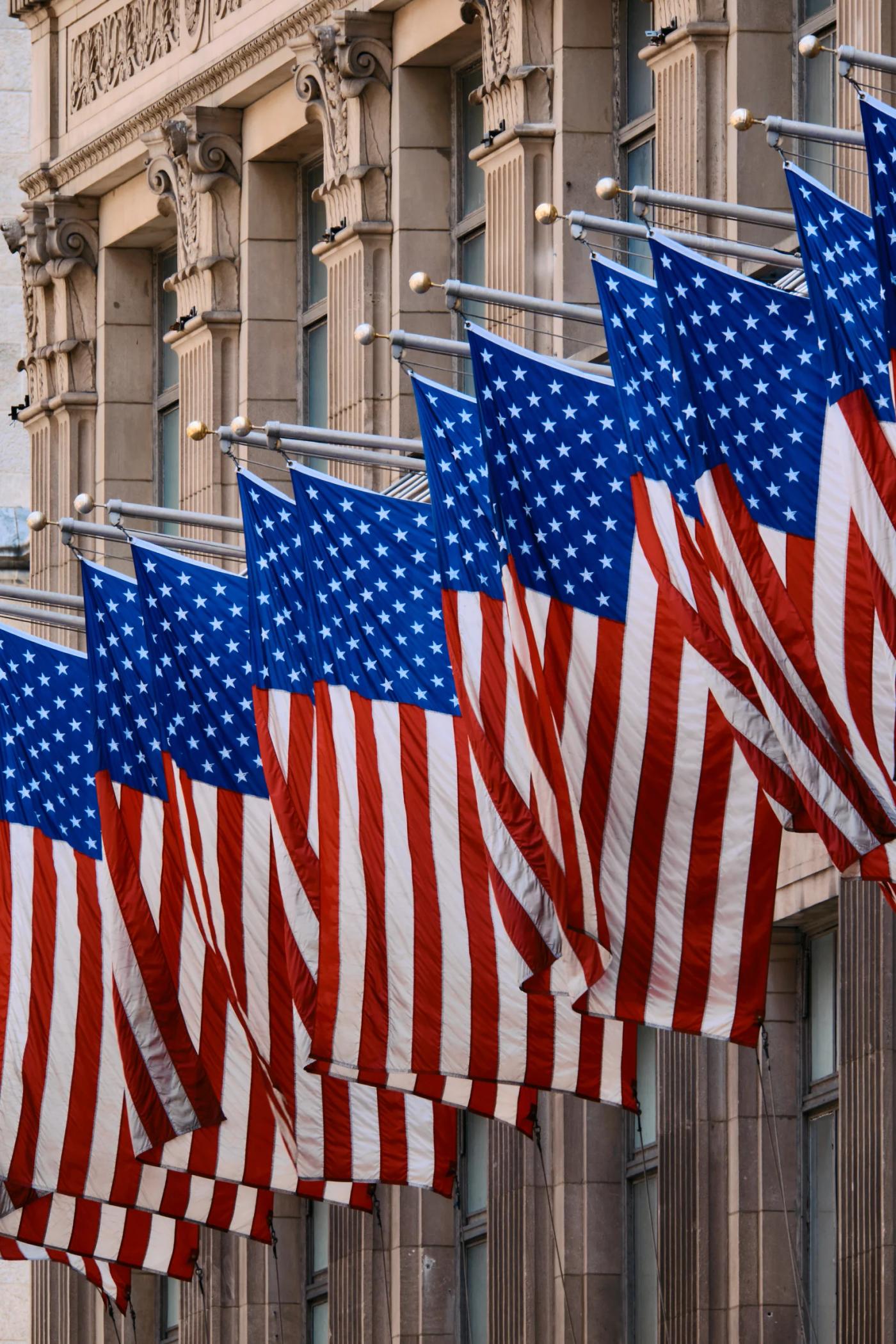 American flags hang from a building, creating a patriotic scene.