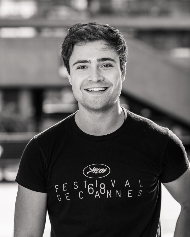 Smiling portrait of a man in a black T-shirt in an industrial interior