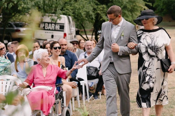 Groom arriving at the wedding ceremony with his mother.