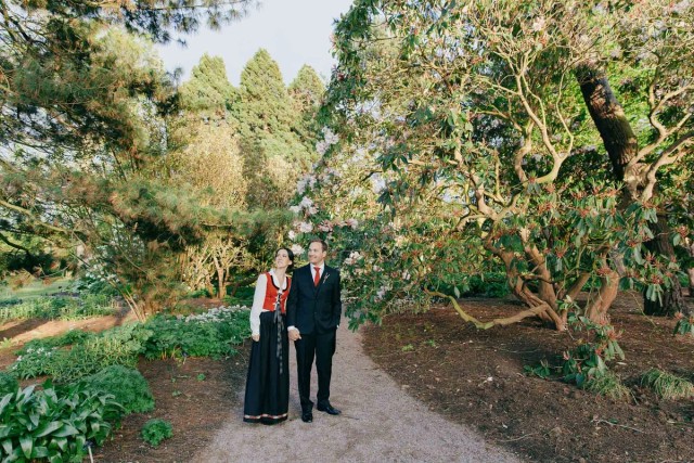 Couple holding hands in Edinbugh Botanic Garden, serene woodland setting