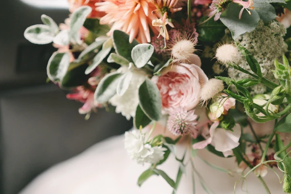 Bridal bouquet — pink roses, coral flowers, silvery eucalyptus and delicate dried flowers