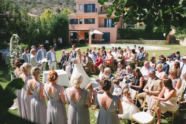 Ceremony at the villa garden — bride stands before the altar, groom and witnesses around her