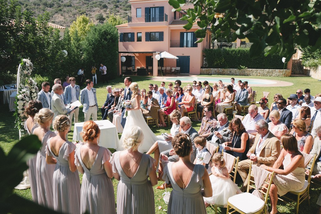 Ceremony at the villa garden — bride stands before the altar, groom and witnesses around her