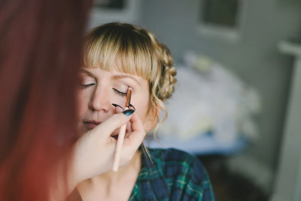 Bride's makeup final touches before the ceremony, blue eyeshadow, face in natural light