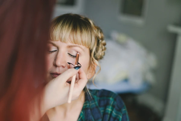 Bride's makeup final touches before the ceremony, blue eyeshadow, face in natural light