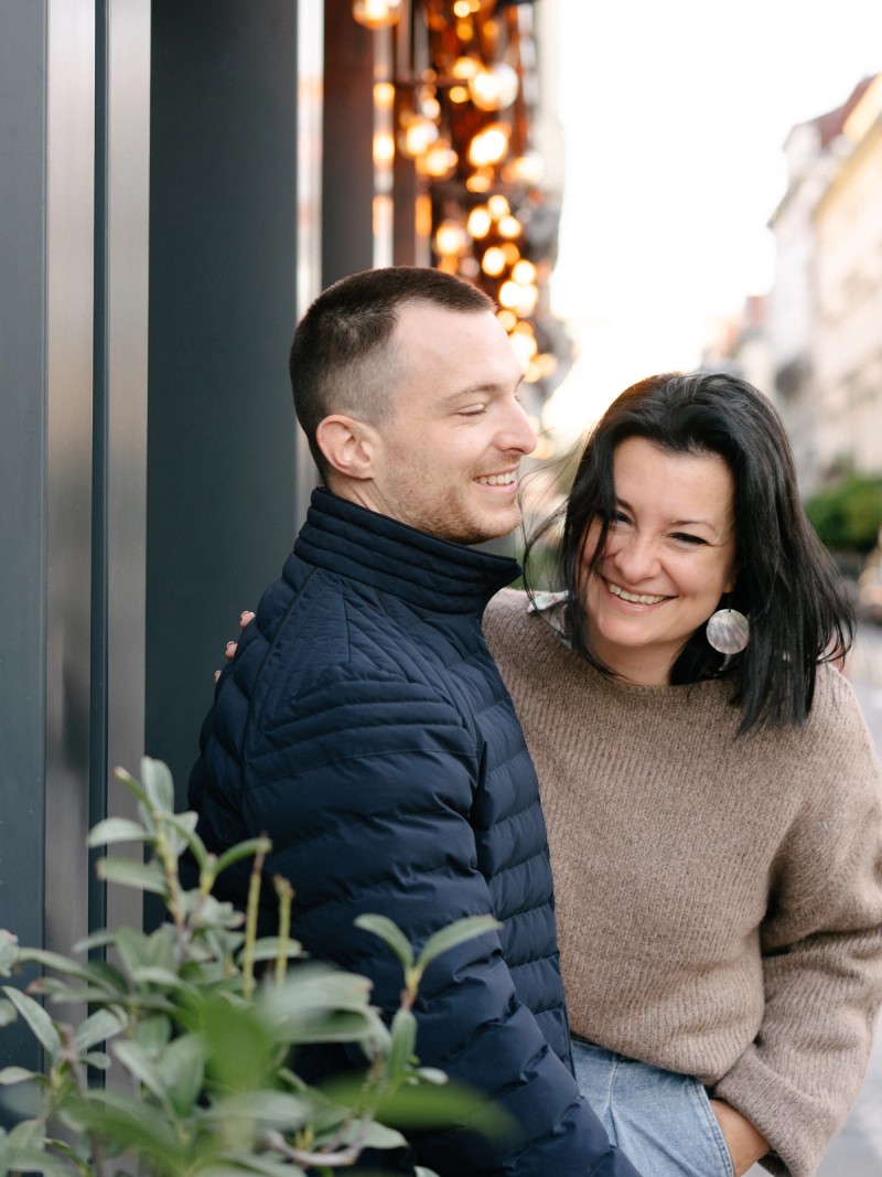 Jegyespár jegyesfotózáson Budapesten, mosolyognak és ölelik egymást a belvárosban.