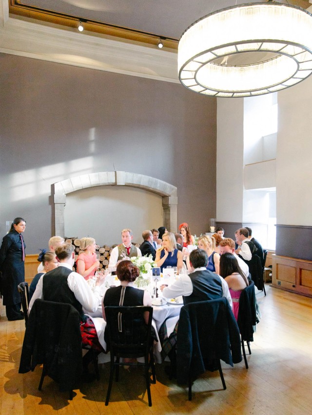 Wedding breakfast at in the Queen Ann room at the Edinburgh Castle, wedding guests sitting around tables and being served by castle staff