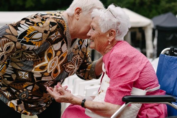 Elderly lady chatting with wedding guest.