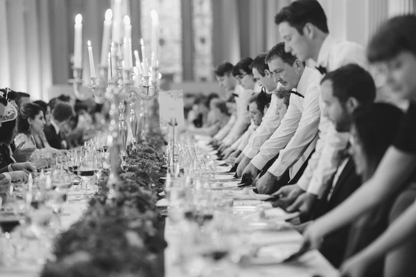 Wedding banquet with white tablecloth, silver candelabra and floral decoration — elegant room