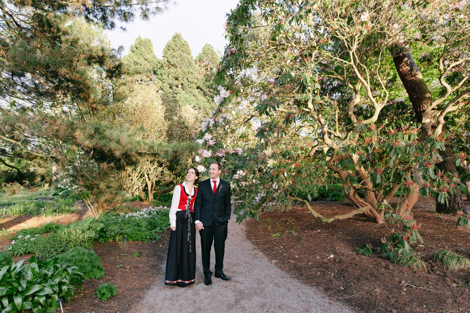 A Norwegian-Scottish couple walking in the Royal Botanic Garden in Edinburgh amongst beautifully lit plants