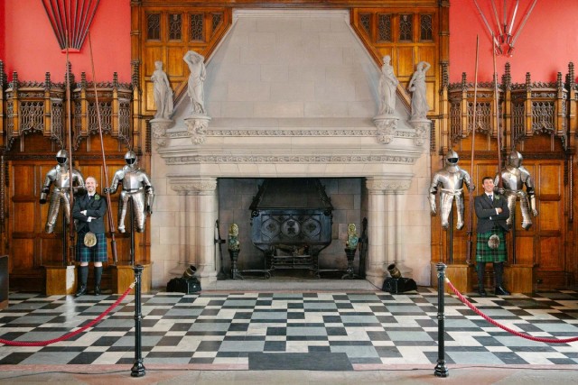 The Great Hall in the Edinburgh Castle with weaponry displayed next to the fireplace